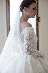 Elegant Off-Shoulder Sweetheart A-Line Wedding Gown with Long Sleeves, Lace, and Crystal Appliques