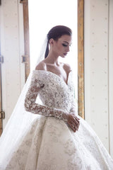 Elegant Off-Shoulder Sweetheart A-Line Wedding Gown with Long Sleeves, Lace, and Crystal Appliques