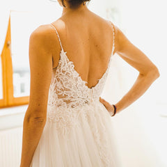 Elegant A-Line Wedding Gown with Spaghetti Straps, Tulle, and Delicate Lace Accents