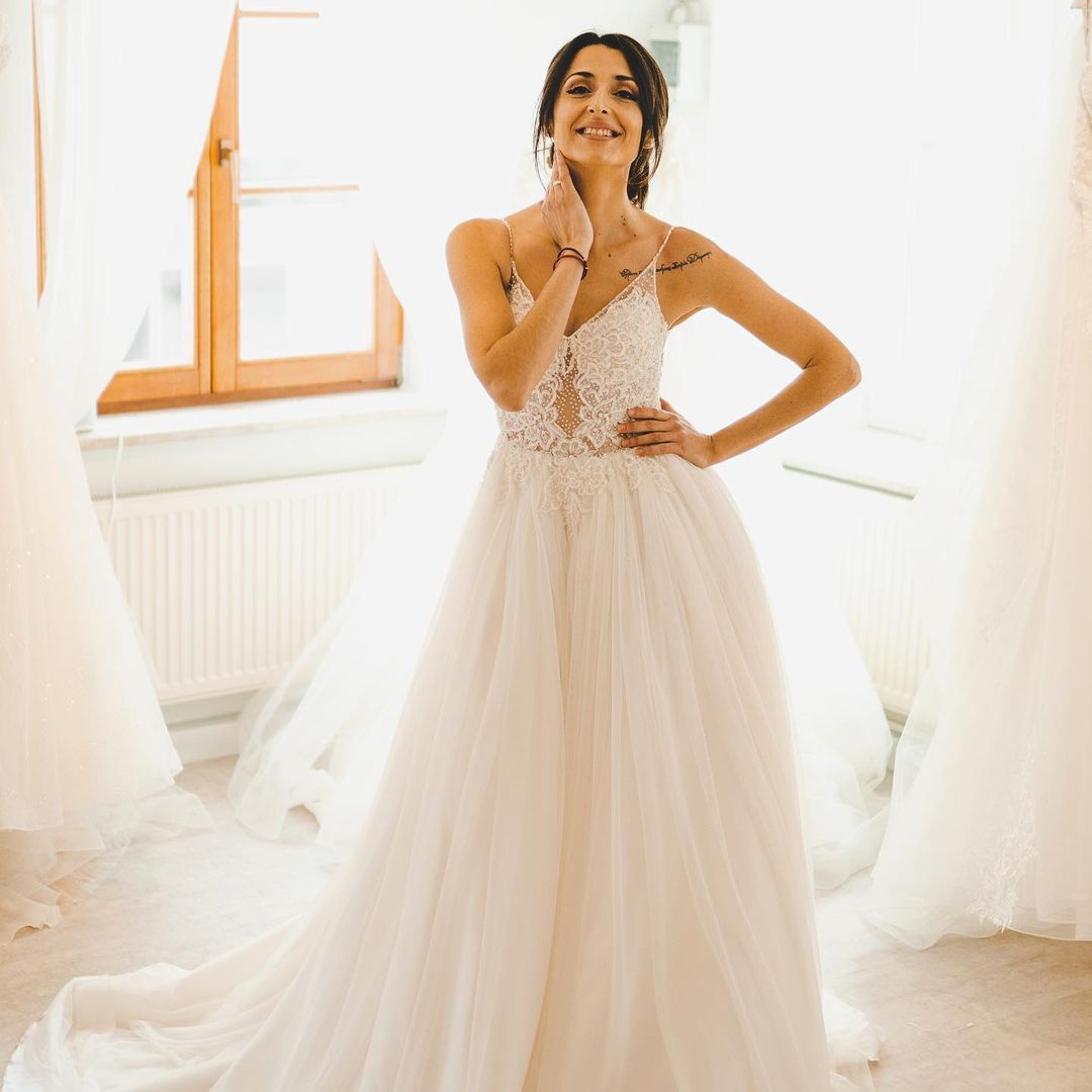 Elegant A-Line Wedding Gown with Spaghetti Straps, Tulle, and Delicate Lace Accents