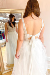 Elegant A-Line Wedding Dress: Deep V-Neck, Spaghetti Straps & Tulle Train